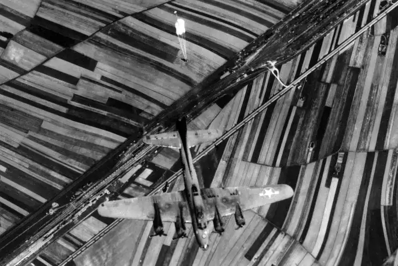 Crew members bailing out by parachute from damaged B-17F Flying Fortress Patches over Austria in 1944.