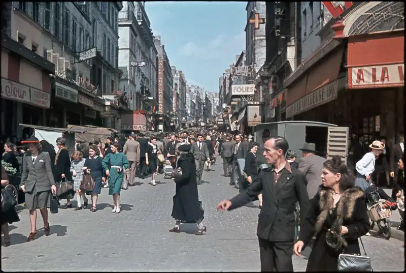 Civilians walking through the Belleville district in occupied Paris, 1942 color photograph