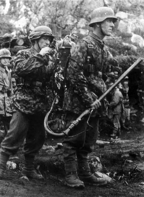 German Army combat engineer operating a Flammenwerfer 35 backpack flamethrower in camouflage outfit during the Invasion of Norway 1940.