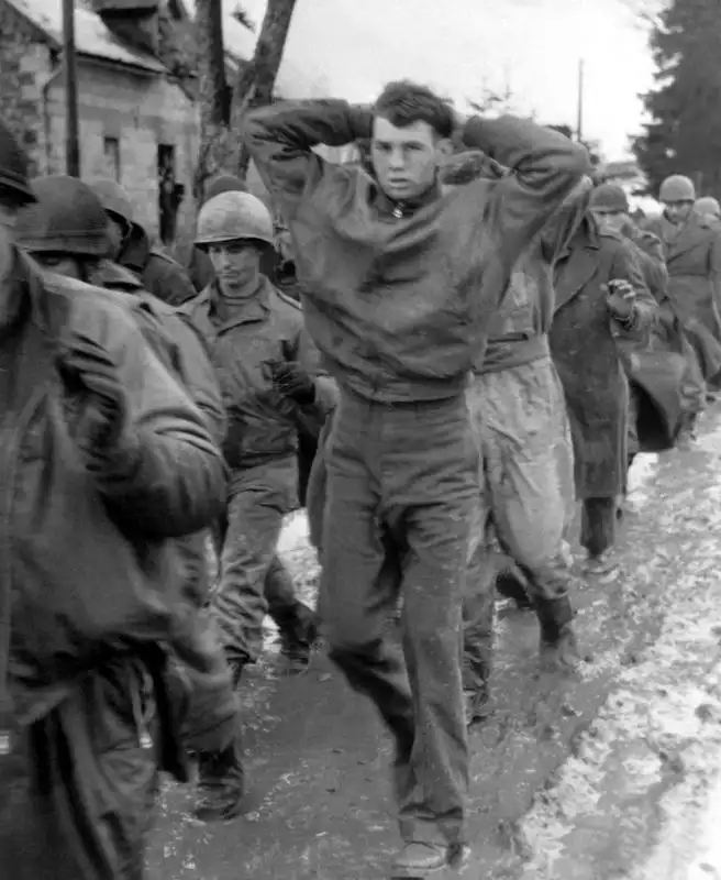 American POWs from the 99th Infantry Division marching through Merlscheid, Belgium, December 1944