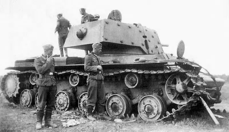 Wehrmacht soldiers inspect a damaged Soviet KV-1E heavy tank, later redesignated as Panzerkampfwagen KV-IB 755(r).