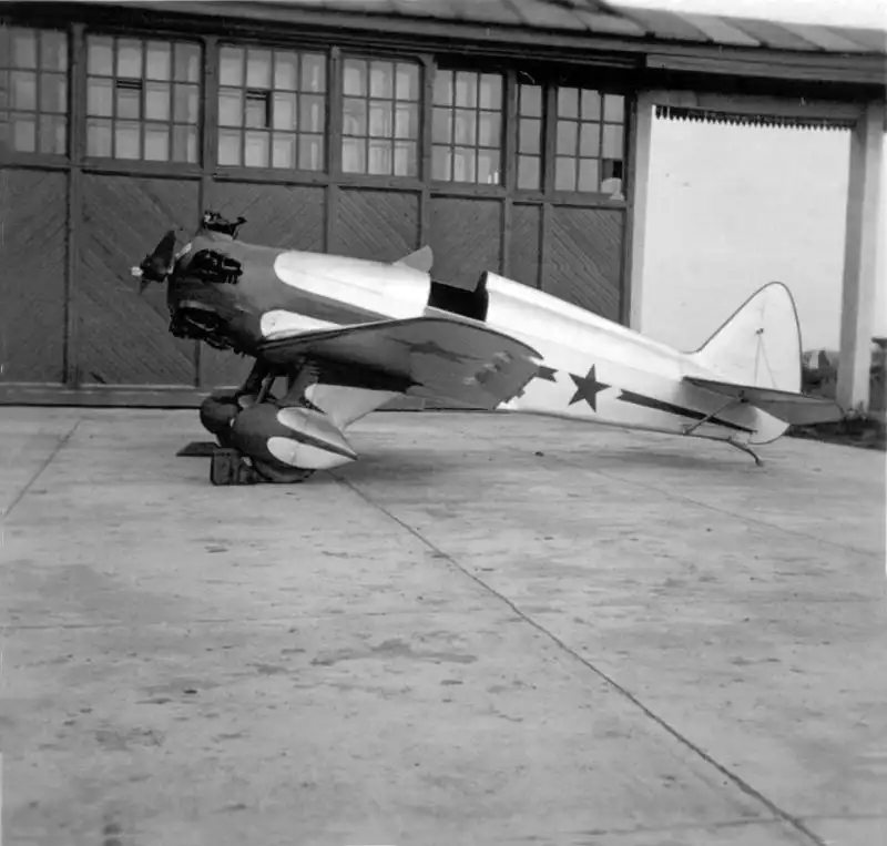 Yakovlev UT-1 Soviet single-seat trainer aircraft with streamlined wheel spats at the factory hangar 1936.