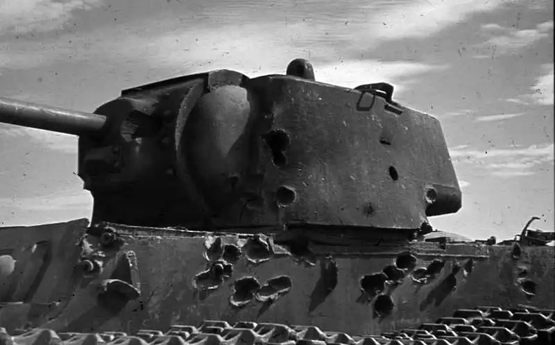 Close-up of a Soviet KV-1 heavy tank turret and hull showing numerous shell hits and armor indentations in Stalingrad, August 1942.