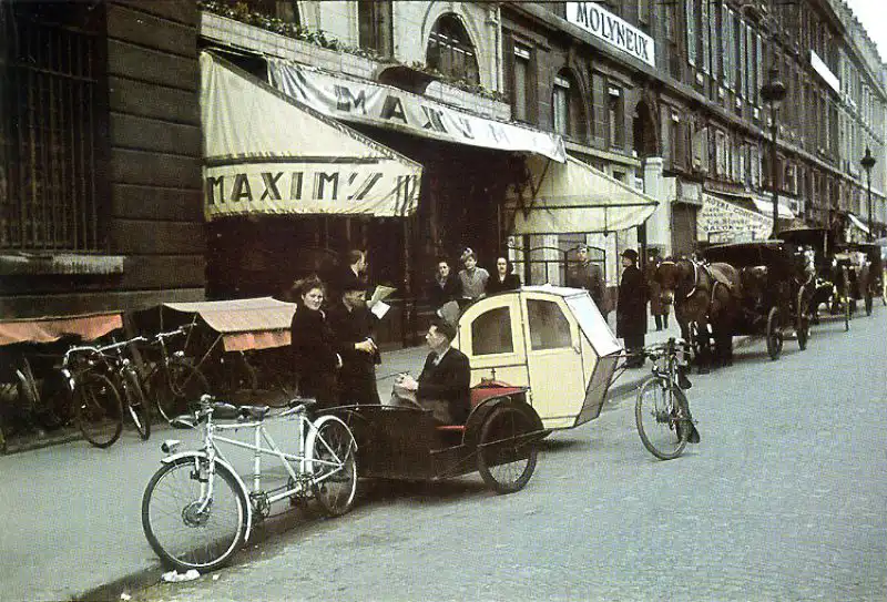 Bicycle taxis waiting outside Maxim’s restaurant in occupied Paris, 1942 color WWII photo