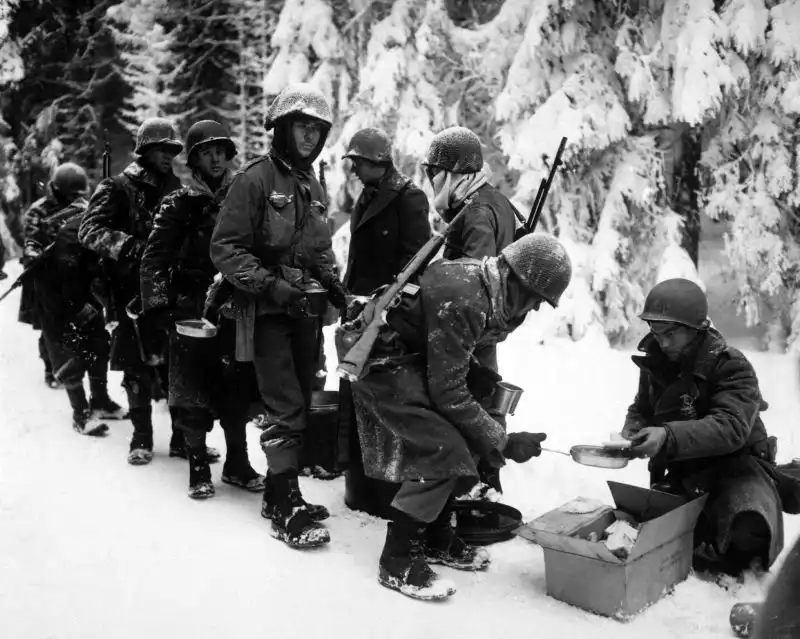 U.S. soldiers receiving rations during the Battle of the Bulge, Ardennes, January 1945