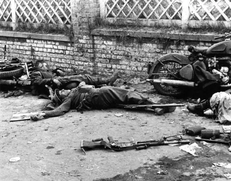 Fallen French motorcycle troops beside British-made military equipment during the Battle of France, May 1940.