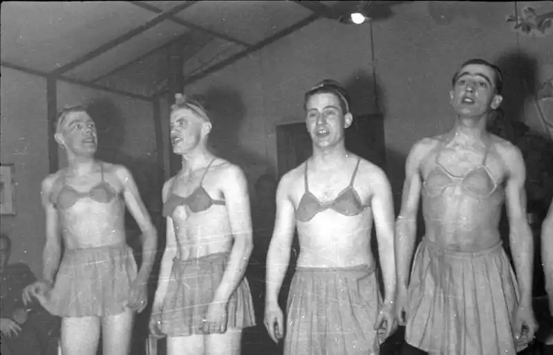 German Wehrmacht soldiers in women's clothing and makeup performing a comedy show for Gebirgsjäger mountain troops in Lapland during World War II, 1943.
