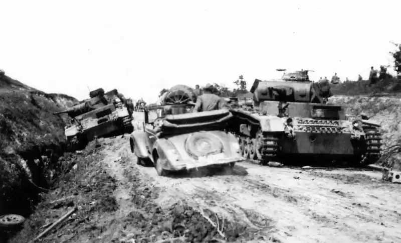 Destroyed German Pz.Kpfw. III Ausf.G tanks on a rural road after a Soviet ambush in the USSR, 1941.
