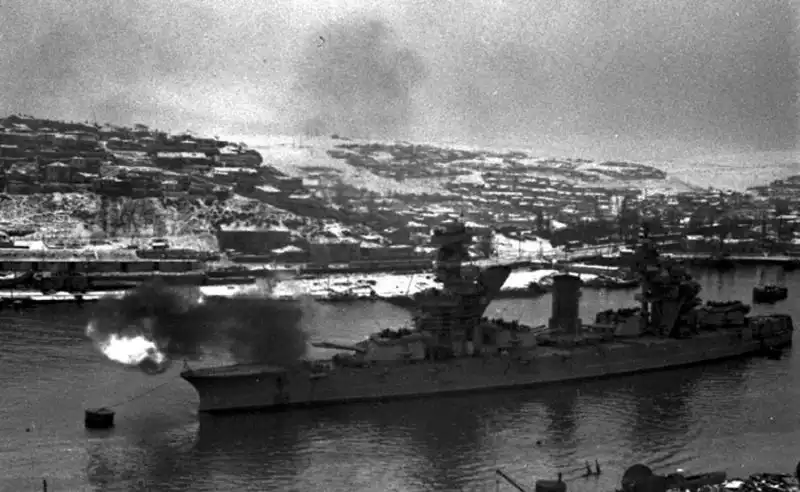 Soviet Gangut-class battleship Parizhskaya Kommuna firing 305mm main battery guns in Yuzhnaya Bay during the Siege of Sevastopol in December 1941.