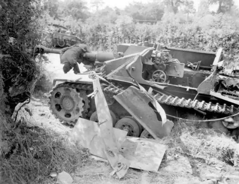 Destroyed German StuG III and Fallen Crewman Near Roncey, France, 1944