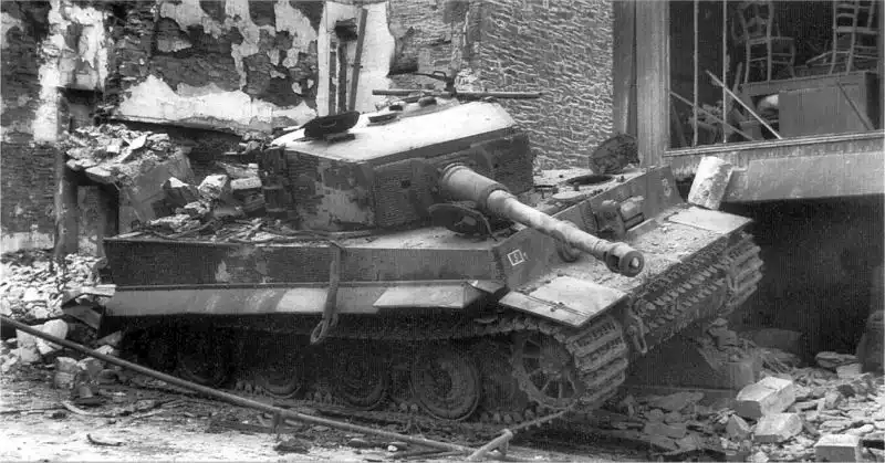 German Tiger I tank No.121 destroyed at Villers-Bocage, Normandy, June 1944, lying on a ruined street after Wittmann’s battle.