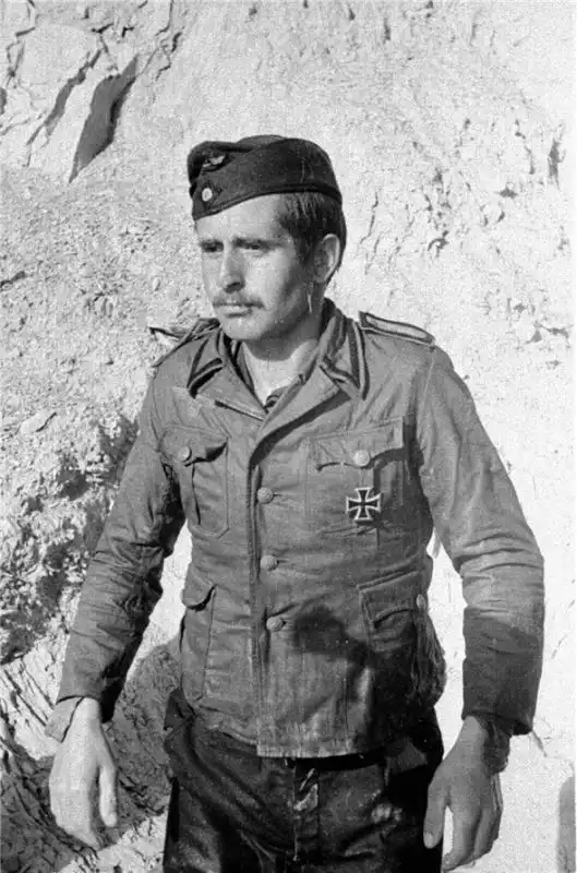 Black and white WWII photo by Evgenii Khaldei depicting a captured German Kriegsmarine sailor wearing a tropical tunic with an Iron Cross 1st Class pinning on his chest.