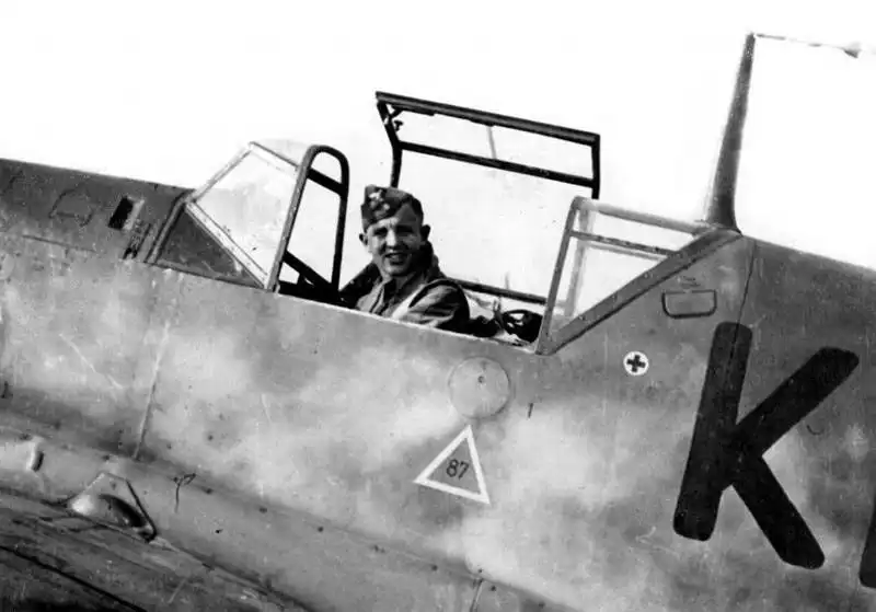 Smiling German Luftwaffe pilot sitting in the cockpit of a Messerschmitt Bf 109D fighter, Germany, 1938.