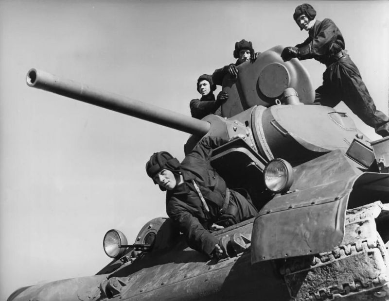Soviet T-34-76 tank crew posing on their tank for Life magazine photographer Margaret Bourke-White, USSR, spring 1941.