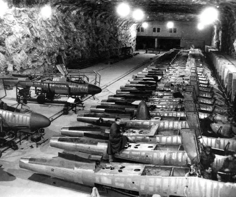 Assembly line of Heinkel He 162 Salamander jet fighters inside an underground Junkers aircraft factory in former salt mines at Tartun, Germany, 1945