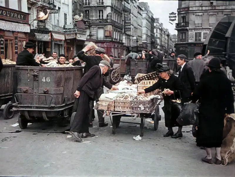 Civilians searching garbage bins for food in occupied Paris, 1942 color photograph
