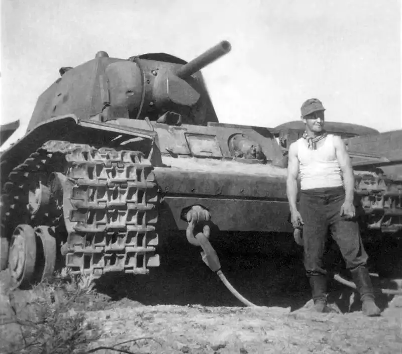 A Wehrmacht soldier poses next to a captured Soviet KV-1 heavy tank