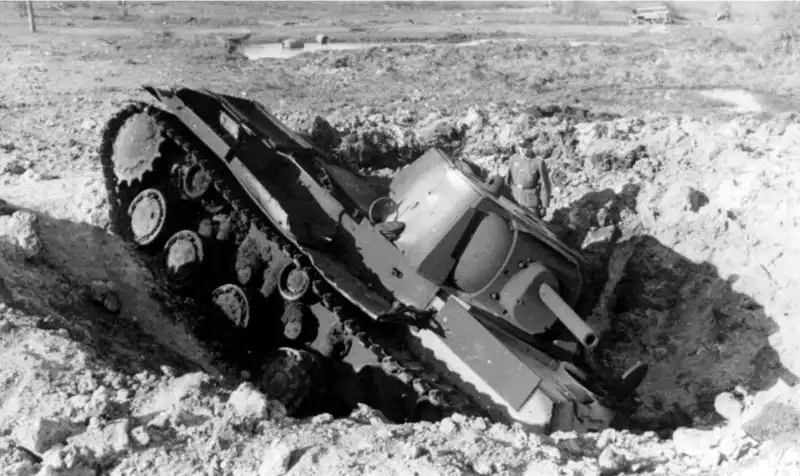 Soviet KV-1 heavy tank abandoned in a crater after a Luftwaffe air raid, 1941, showing the early Soviet losses