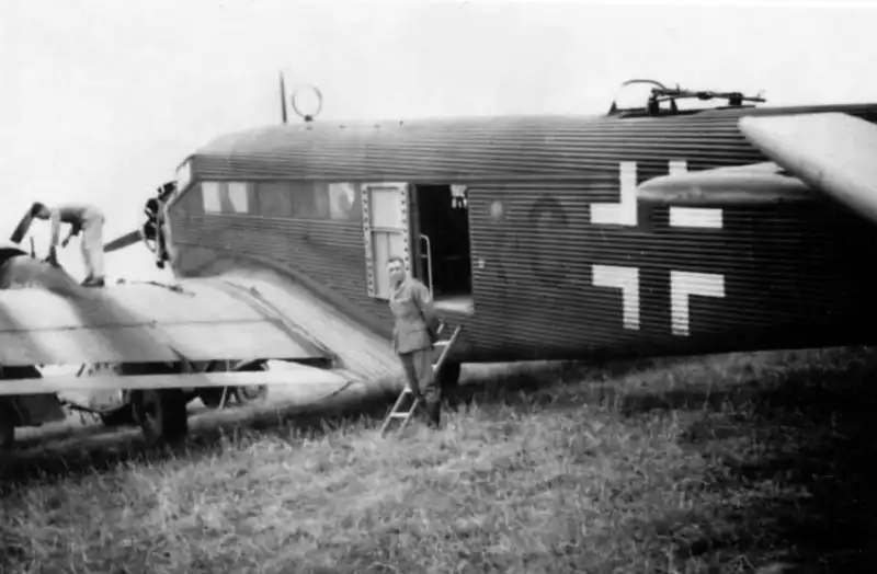 Junkers Ju 52 transport aircraft at a Luftwaffe airfield in Germany undergoing engine maintenance with ground crew, 1937