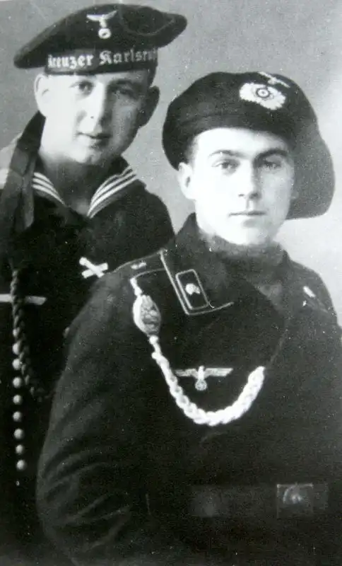 Studio portrait of a German Kriegsmarine sailor from cruiser Karlsruhe and a Panzer tanker wearing early padded beret 1938.