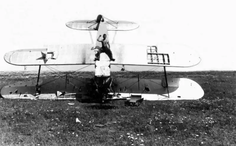 Downed Soviet U-2 biplane during an emergency landing in Summer 1941, with a German soldier on the wreckage.