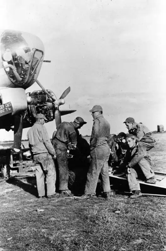 American ground crew repairing B-17 Flying Fortress landing gear at Poltava airbase, Ukraine, 1944, during shuttle bombing operations.