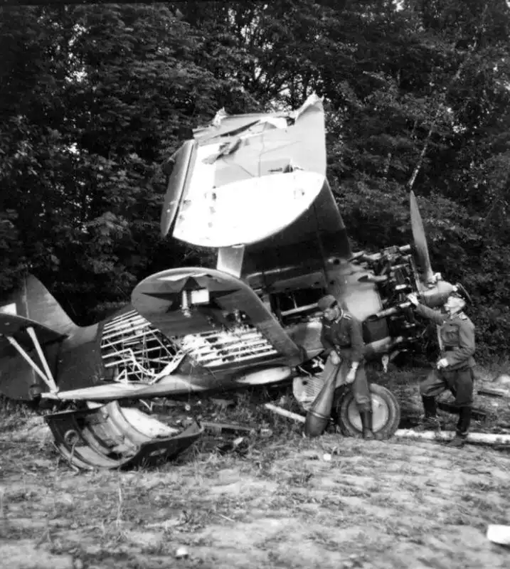 German soldiers inspect the wreckage of a Soviet Polikarpov I-153 “Chaika” biplane fighter, captured in the western USSR during the Nazi invasion in summer 1941.