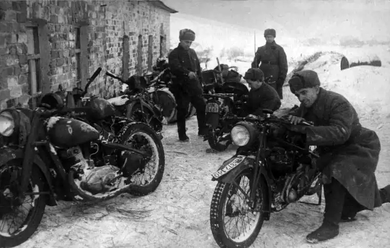 Soviet Red Army soldiers examining captured German Standard 500 Kurier and DKW NZ 350 motorcycles winter 1941.
