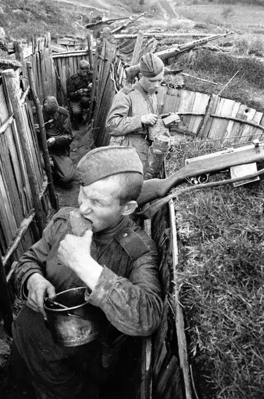 Soviet soldiers eating in a trench on the front line, 1943