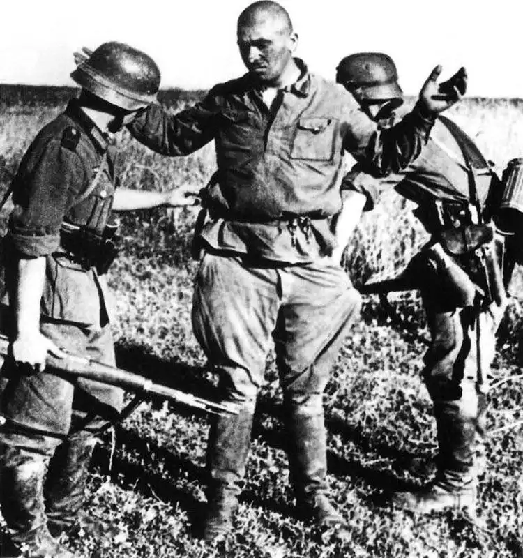 German soldiers searching a captured Red Army soldier in the Rzhev region, May 1942