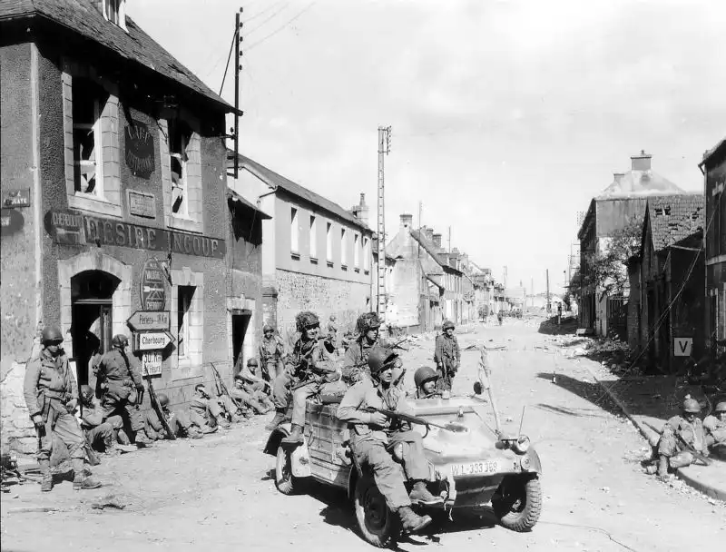 American soldiers of the 101st Airborne Division resting near a captured Volkswagen Type 82 Kübelwagen