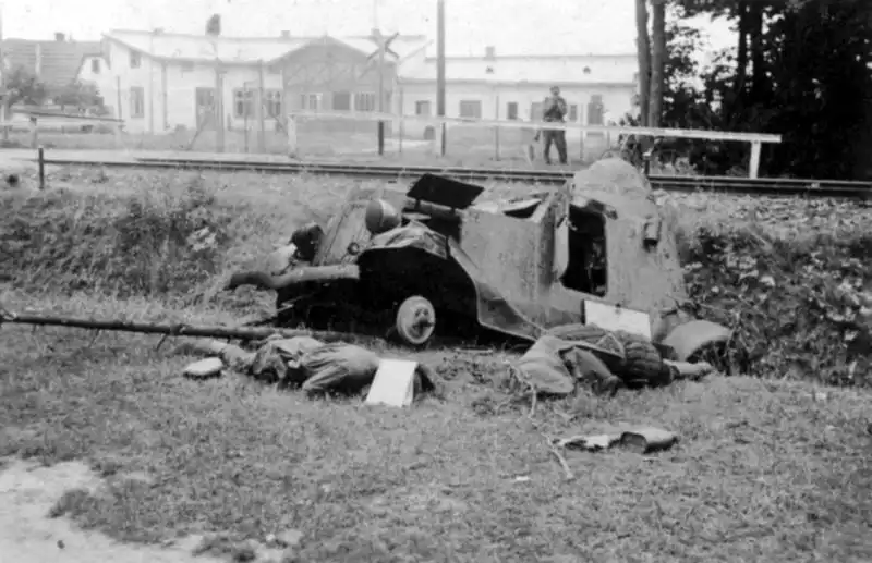 Destroyed Soviet FAI-ZhD armored railcar and fallen crew beside a railway line during the German invasion of the Soviet Union in summer 1941