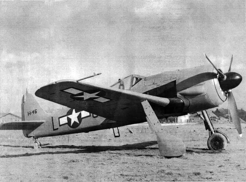 Captured German Focke-Wulf Fw 190A-8 fighter aircraft repainted bright red-orange by American forces at Saint-Trond airfield in Belgium, January 1945