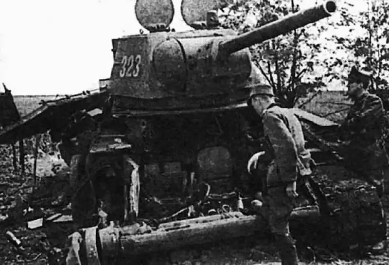 Soviet T-34-76 tank #323, likely destroyed by a heavy mine or aerial bomb. Frontal armor completely breached