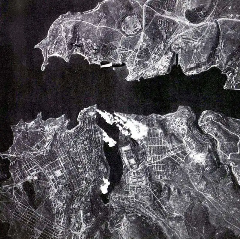 Aerial strike photograph showing German bombs falling into Sevastopol Bay and city center during WWII siege 1942.