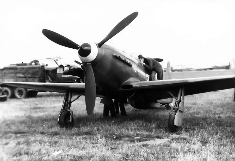 Soviet Yak-3 fighter from the Normandie-Niemen squadron, with American technicians inspecting the aircraft before its flight to France in June 1945.