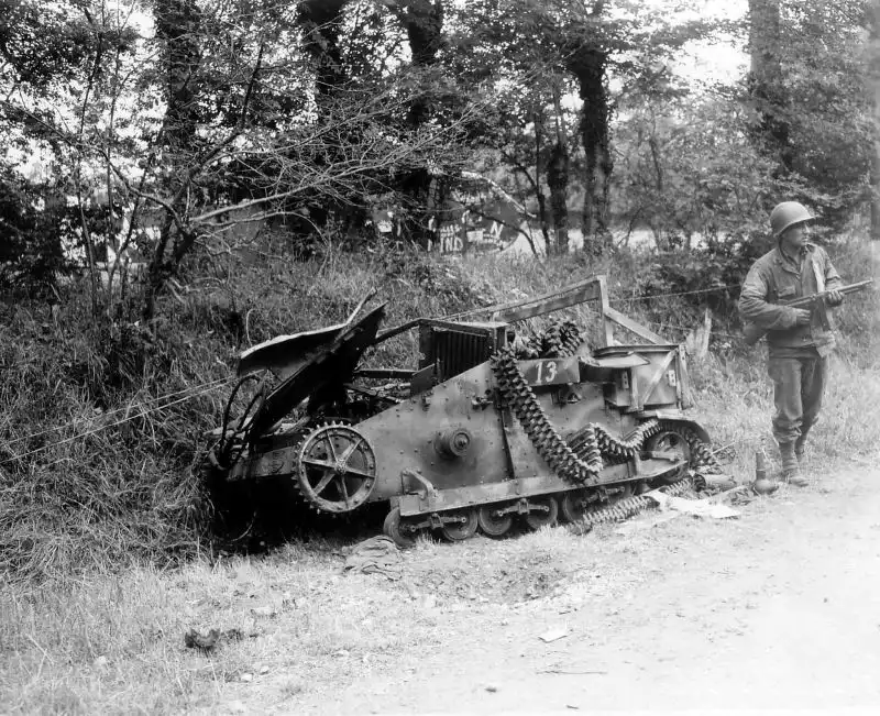 American paratrooper near a destroyed French tankette and crashed Waco CG-4 glider, Normandy, August 1944.