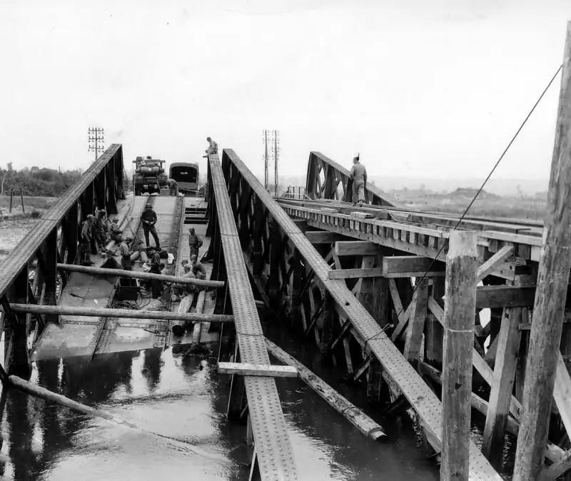 American engineers repairing a bridge in France for tank units during the Liberation of France, Summer 1944.