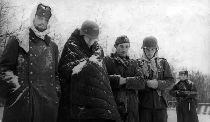 Four German prisoners of war guarded by a Red Army soldier during the Soviet counteroffensive near Moscow, December 1941.