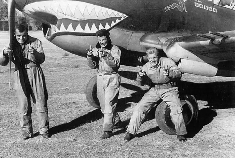 Flying Tigers pilots posing with Curtiss P-40 fighter in China, 1942