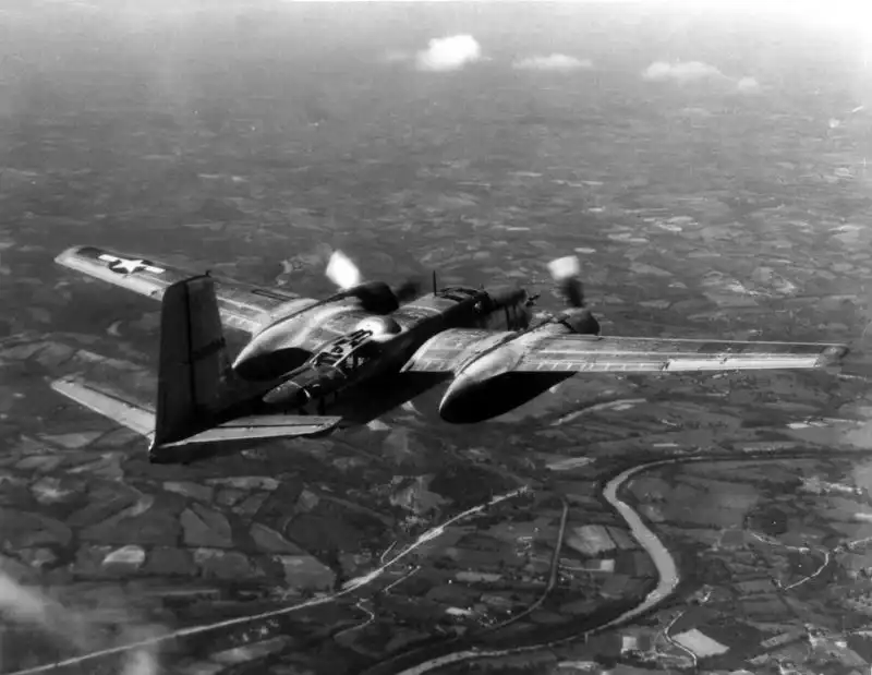 American Douglas A-26 Invader twin-engine bomber flying over countryside during WWII.
