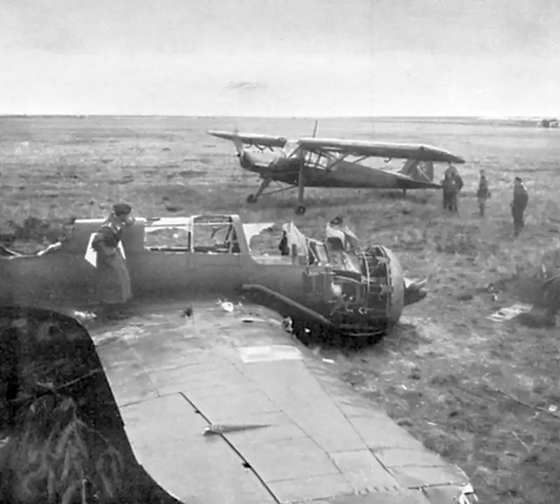 Destroyed Polish PZL P.23 Karaś bomber beside a German Fieseler Fi 156 Storch at a captured airfield in Poland, September 1939.
