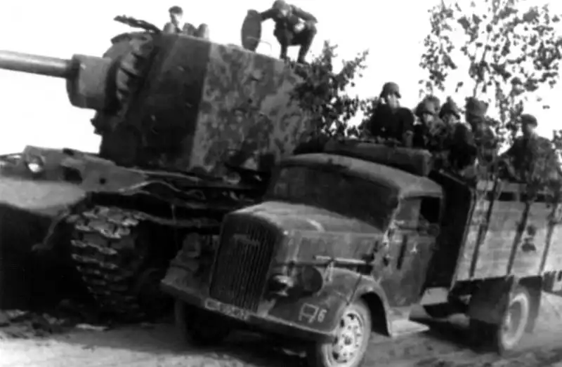 German Opel Blitz truck passing a knocked-out Soviet KV-2 heavy tank, USSR, 1941