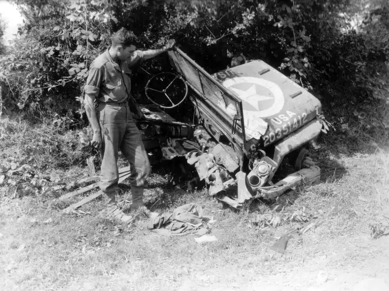 Destroyed Willys Jeep after hitting a German anti-tank mine near Saint-Sever-Calvados, France, 1944