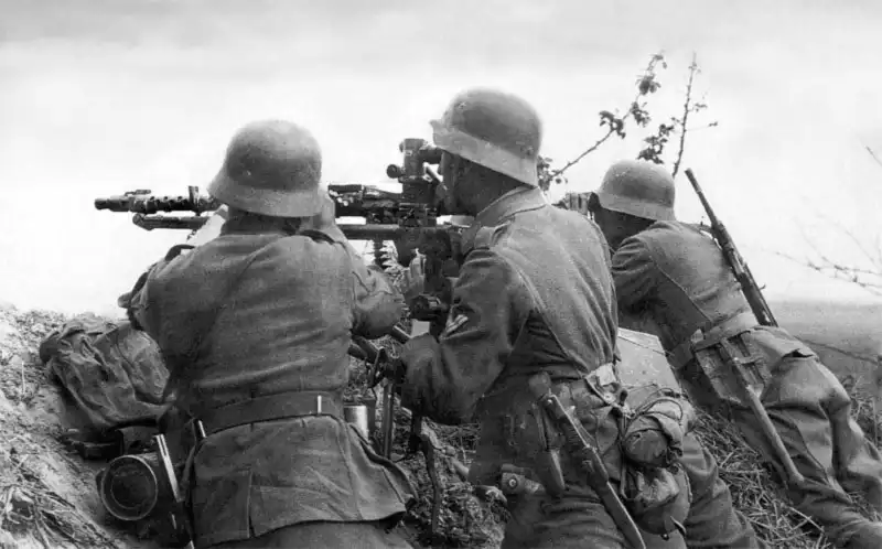 German Wehrmacht machine gun crew firing an MG-34 on Lafette 34 tripod with MG Z.34 scope 1941.
