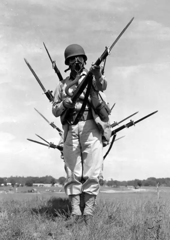American soldiers posing with M1 Garand rifles and bayonets during training at Fort Benning, Georgia, August 1941.