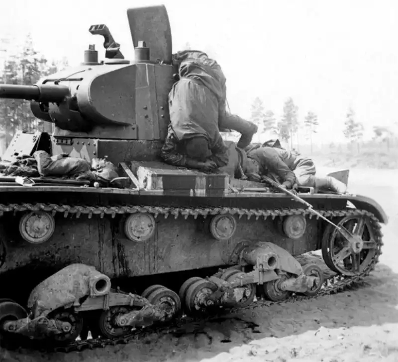 Fallen Soviet tank crewmen and tank riders lying on a damaged T-26 light tank near Daugavpils during the border battles of summer 1941.