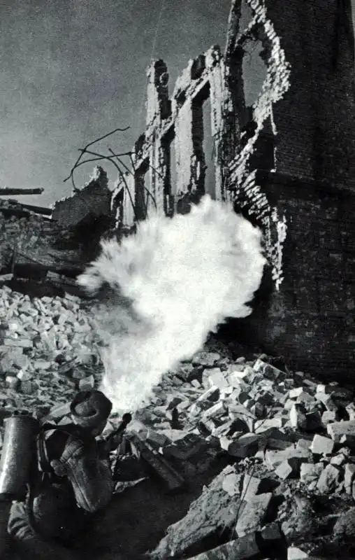 Soviet flamethrower operator A.D. Puchkov fires at German troops entrenched in the lower floor of a ruined building during the Battle of Stalingrad