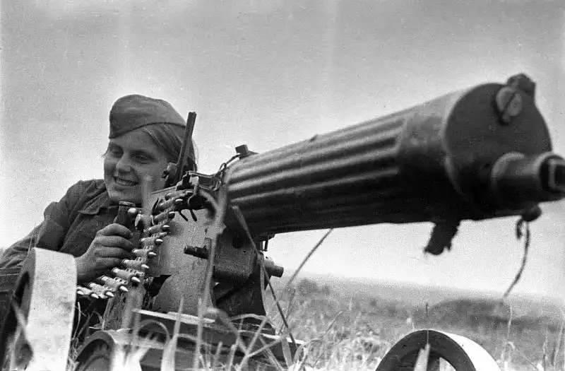 Guards Private Zinaida Kozlova, female Soviet machine gunner of the 1st Guards Cavalry Corps, posing with her Maxim machine gun, USSR, June 1942.