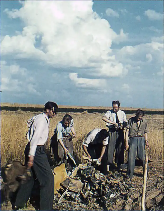 German engineers examining wreckage of a Blohm & Voss Bv 143 anti-ship guided missile at Peenemünde, August 1941 (color photograph).